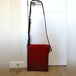 Unisex red leather bag with ink printed skull image on the backside.